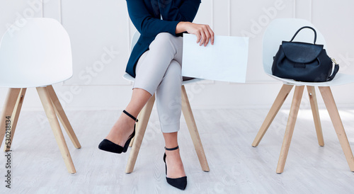 Business woman in waiting room for recruitment, we are hiring or Human Resources with CV, resume or contract paper. Shortlisted person at corporate interview for job or career opportunity in HR photo
