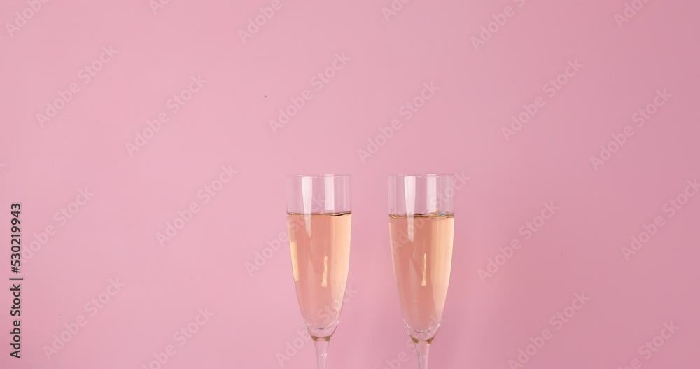 New years eve celebration pink background with champagne glasses New years eve celebration pink background with champagne glasses