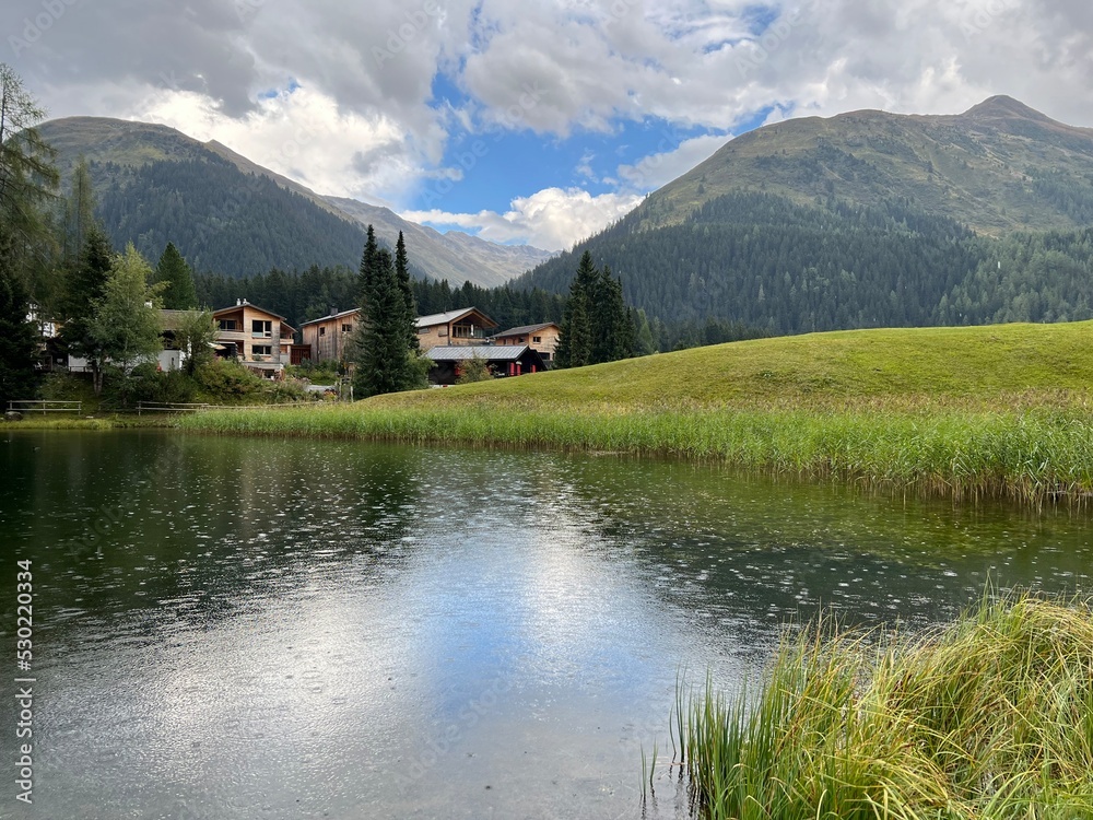 Fototapeta premium Alpine mountain lake Schwarzsee or Black Lake between the tourist towns of Davos and Klosters - Canton of Grisons, Switzerland (Kanton Graubünden, Schweiz)