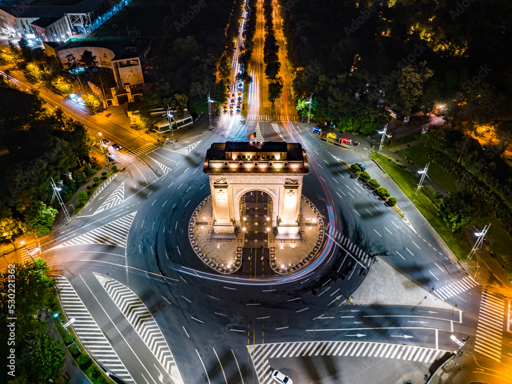 Bucharest, Romania. June, 17th, 2022. 
Aerial night shot of the Arch of Triumph ( Arcul de Triumf) in Bucharest the Romanian capital.
 - obrazy, fototapety, plakaty 