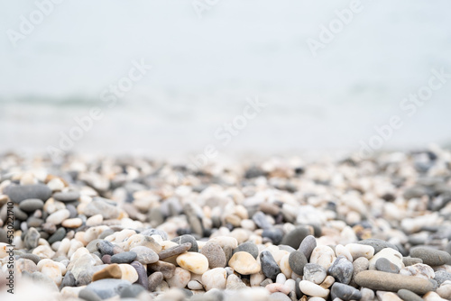 Pebbles on the beach. Black Sea. Beach with colorful rocks. Pebble by the sea. Background from stones. 