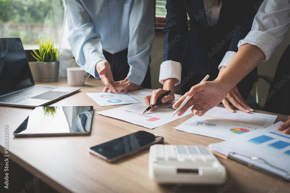 Business team using calculator to calculate the company's financial results and budget. Account Audit Concept Business team using calculator to calculate the company's financial results and budget. Account Audit Concept