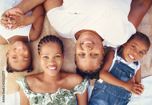 Black family portrait with mother  grandma and children relax for summer vacation  holiday or happy break in sunshine. Big family and kids face smile together lying on ground at beach from above