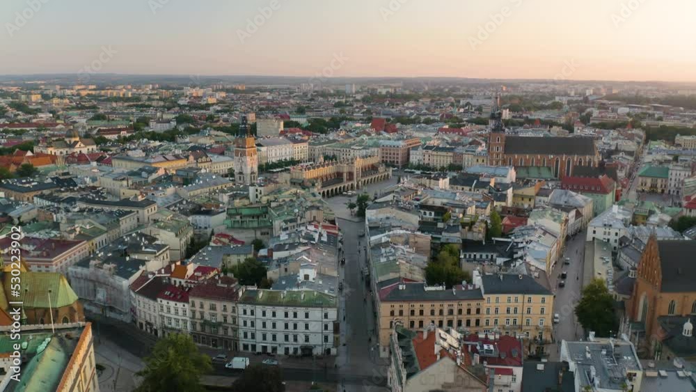 Drone Flies Away from Krakow's Old Town with St. Mary's Church, Town Hall, and Cloth Hall in Background Drone Flies Away from Krakow's Old Town with St. Mary's Church, Town Hall, and Cloth Hall in Background