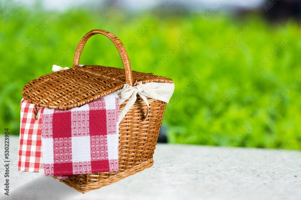 A picnic basket on table on outdoor background. Shavuot holiday A picnic basket on table on outdoor background. Shavuot holiday