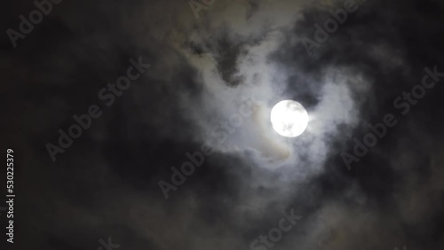 full super moon through gloomy clouds