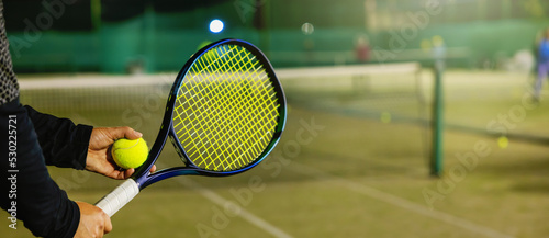 tennis player with racket and ball in hands ready to play. banner with copy space © ronstik