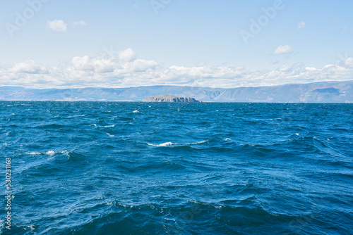 Clear fresh water and panorama of Lake Baikal on a summer day. 