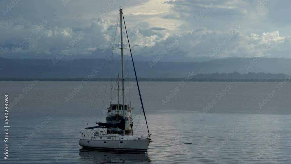 Static handheld shot of a sailing boat with furled sails in the afternoon. Bocas del Toro, Panama Static handheld shot of a sailing boat with furled sails in the afternoon. Bocas del Toro, Panama