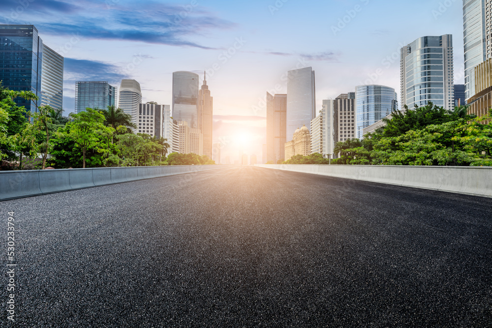 Straight asphalt road and modern city skyline with buildings in Guangzhou at sunset, China. Straight asphalt road and modern city skyline with buildings in Guangzhou at sunset, China.