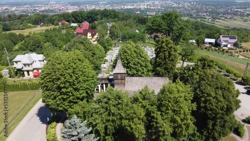 St. Martin's Hill (Góra Św. Marcina (Zabłocie)) in Tarnów, Poland. Site of the St Martin the Bishop Wooden Church, cemetery, and Tarnowski Castle ruins - Zawada- 4K 30FPS Drone Tracking Back photo