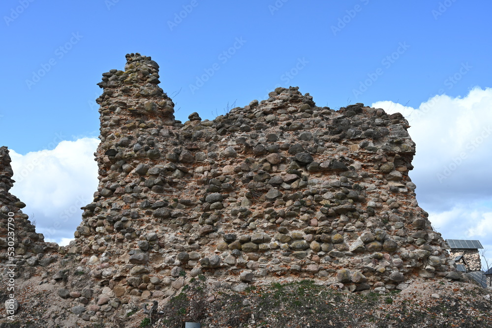 Ruins of an old castle against a blue sky. High quality photo