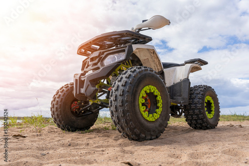 ATV on the sandy shore of the lake. front side view. © Андрей Знаменский