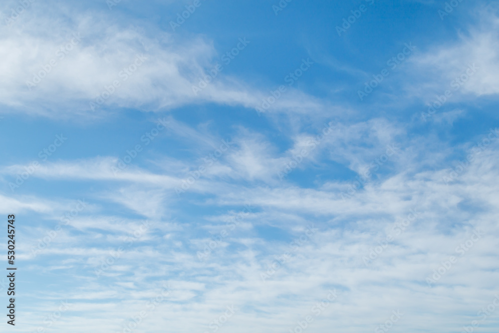 White fluffy clouds in the blue sky. Blue sky background and white clouds soft focus, pastel sky