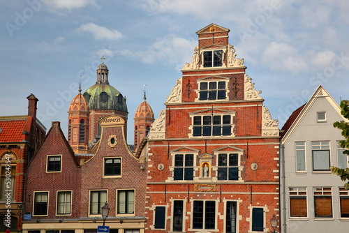 The colorful facades of historic houses located along Kerkstraat street in the city center of Hoorn, West Friesland, Netherlands, with the Butter House (Boterhal, built in 1563) in the center