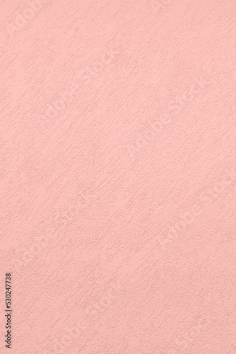 Saturated pastel light pink colored low contrast Concrete textured background. Empty colourful wall texture with copy space for text overlay and mockups. 2023, 2024 color trend