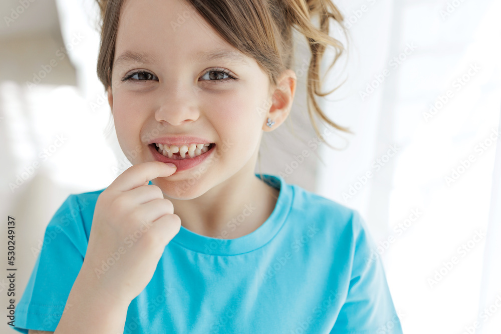 The child has lost a tooth. Little girl without a tooth. The first tooth fell out. High quality photo The child has lost a tooth. Little girl without a tooth. The first tooth fell out. High quality photo