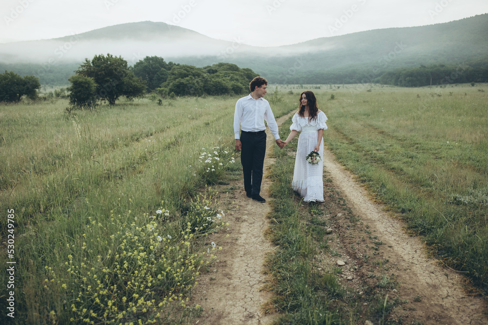Beautiful wedding couple in nature. Wedding. Bride and groom on their wedding day. High quality photo
