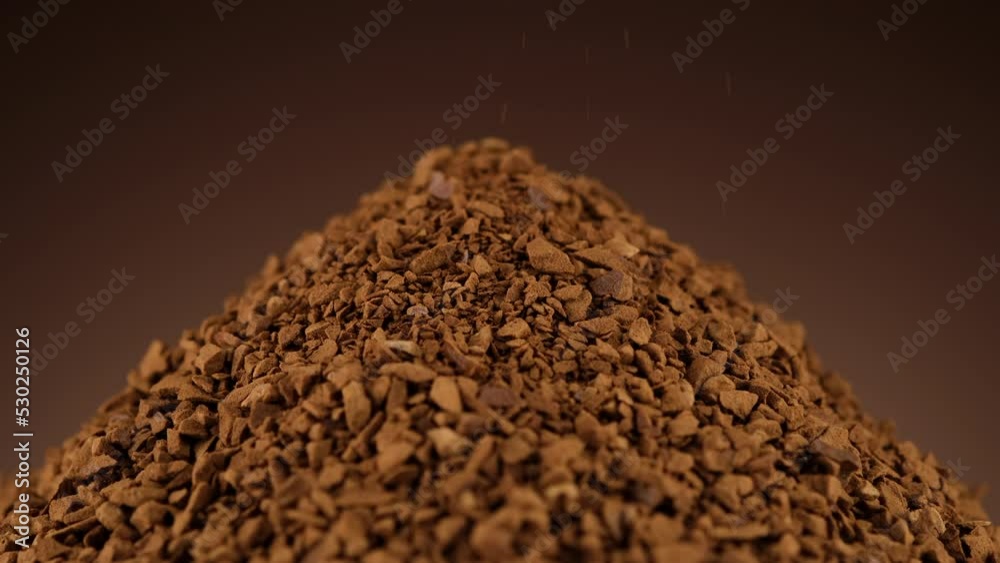 Instant coffee. Pour and rotation instant coffee, brown background Instant coffee. Pour and rotation instant coffee, brown background