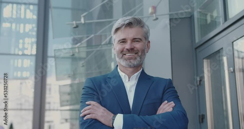 Portrait of Handsome Senior Smart Man Crossing Arms and Looking at the Camera, Smiling. Entrepreneur Standing on Street. Man Contemplating e-Business Ideas, e-Commerce Investment Strategy 
