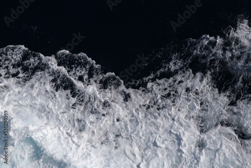 sea waves and foam top view on the sea from travelling ship