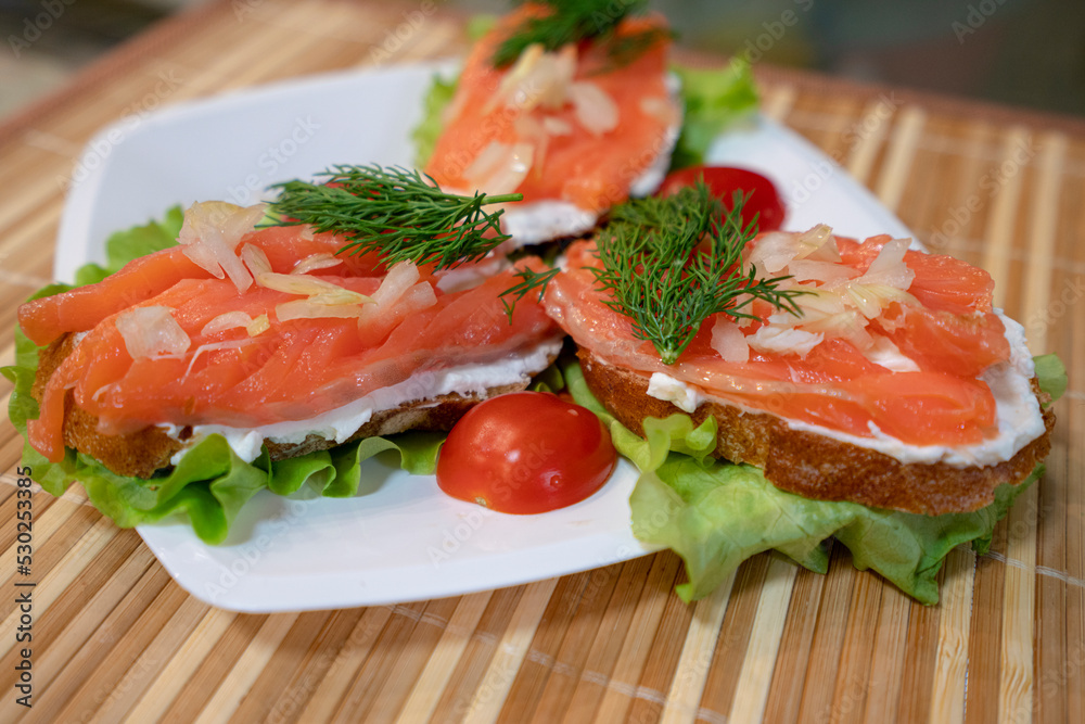 Canapes with salmon on brown background Canapes with salmon on brown background