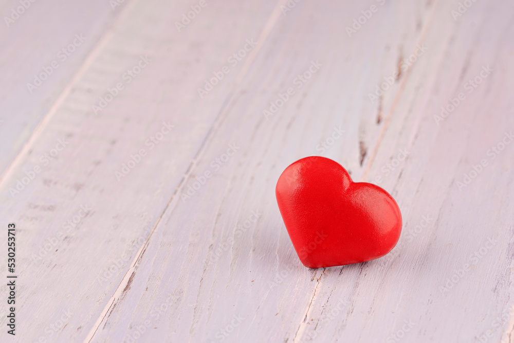 Close up of red hearts on wooden table against defocused lights. St. Valentine's Day background Close up of red hearts on wooden table against defocused lights. St. Valentine's Day background