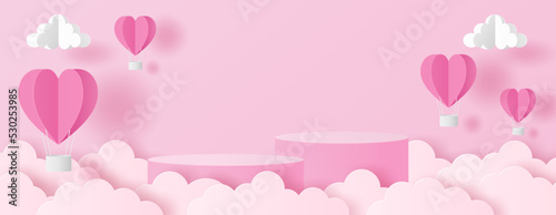 Paper cut of Valentine's Day background with pink cylinder podium, heart hot air balloons and clouds for products display presentation.