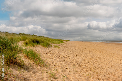 Beautiful view of dunes and sandy walkway to the beach in Yorkshire UK