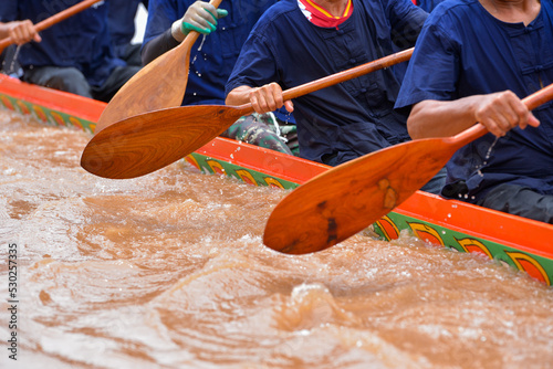close-up paddle that a rower holds and is rowing.