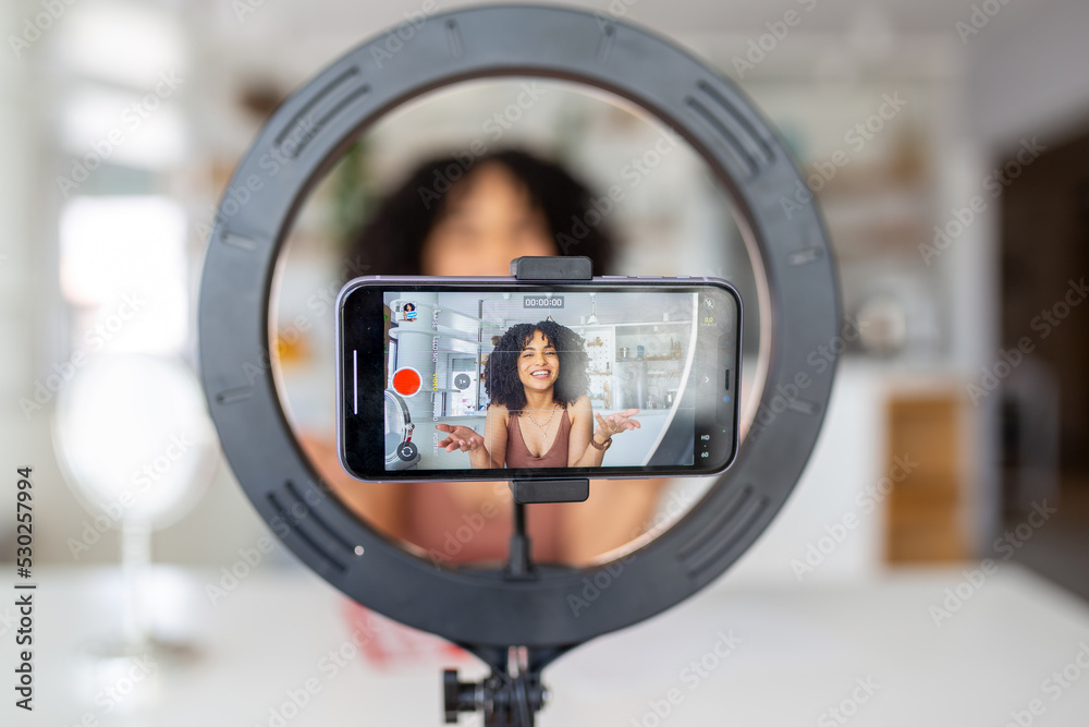 Young female influencer using her smart phone for filming a vlog post. Young female influencer using her smart phone for filming a vlog post.