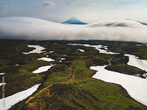 Vilyuchinsky volcano with clouds at sunrise in Kamchatka, Russia. photo