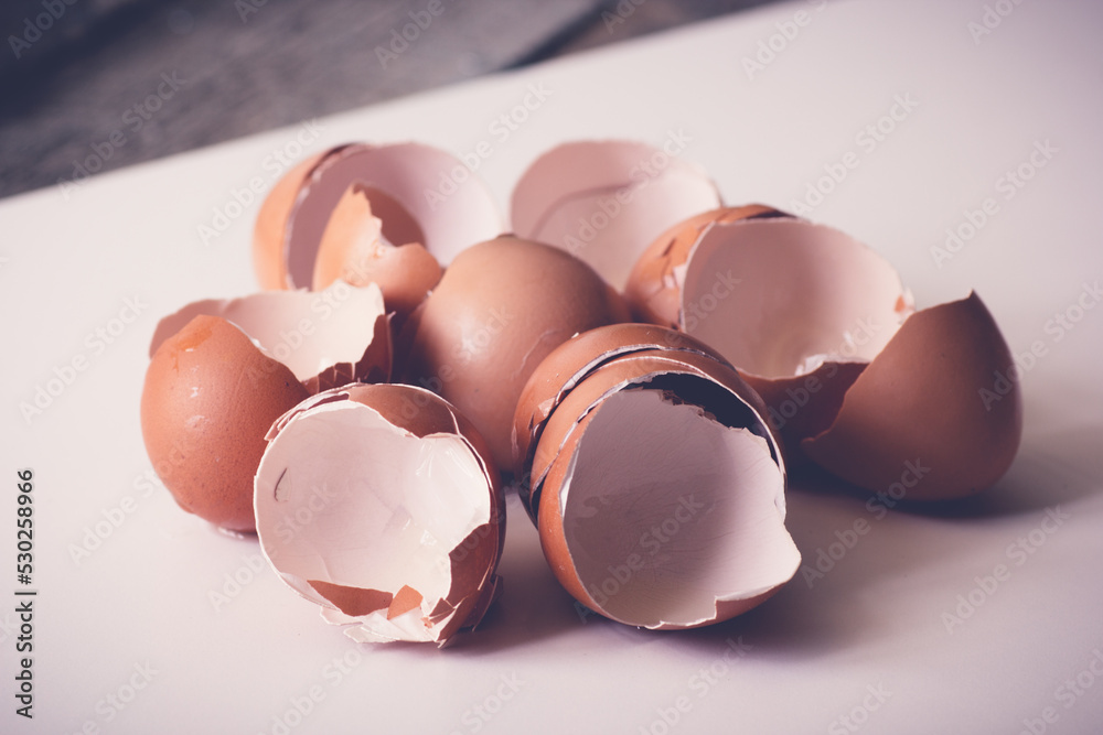 Broken egg shells close up. Eggshell on white table