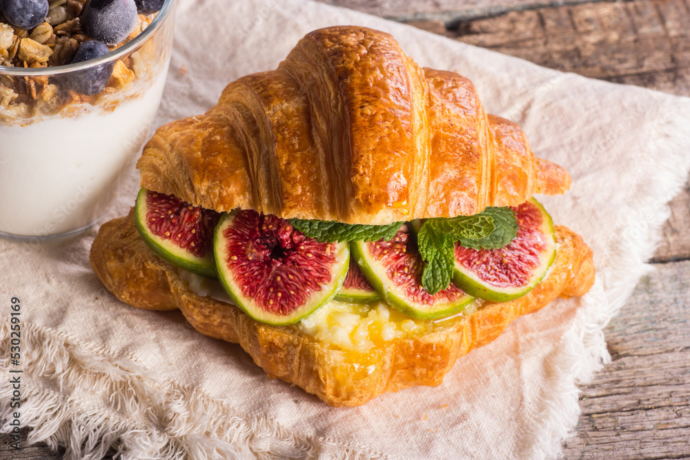 Croissant with healthy dietary filling. Croissant with ricotta cheese, honey and figs.