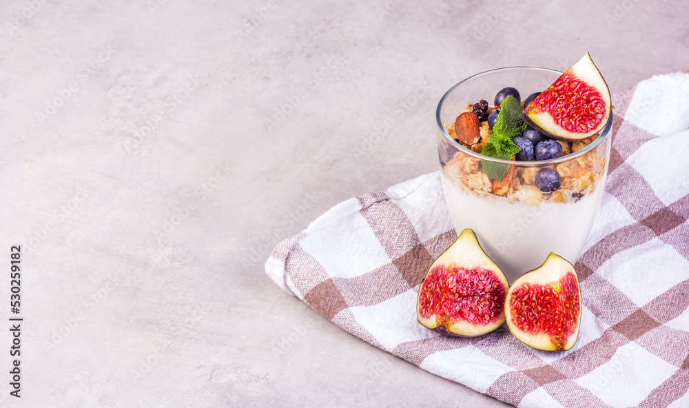 Homemade yogurt with berries and muesli. Yogurt and figs copy space