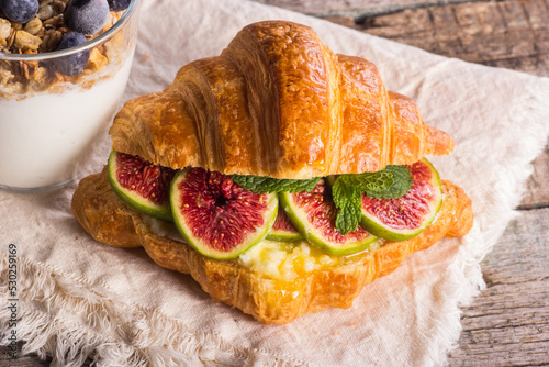 Obraz na płótnie Croissant with healthy dietary filling. Croissant with ricotta cheese, honey and figs. w salonie