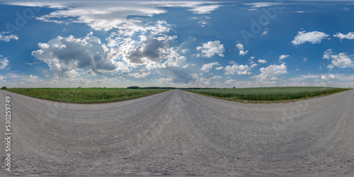 full seamless spherical hdri 360 panorama view on no traffic gravel road among fields with overcast sky and white clouds in equirectangular projection can be used as replacement for sky in panoramas