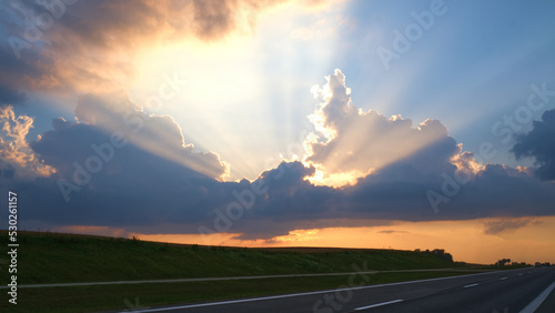 The rays of the sun breaking through the clouds view near the highway