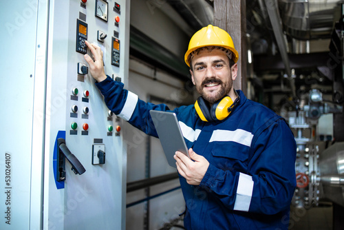 Portrait of electrician with digital tablet checking installations and power supply.