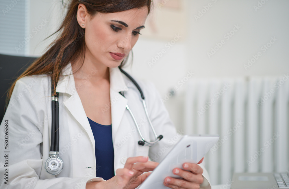 Doctor in her studio using a digital tablet Doctor in her studio using a digital tablet