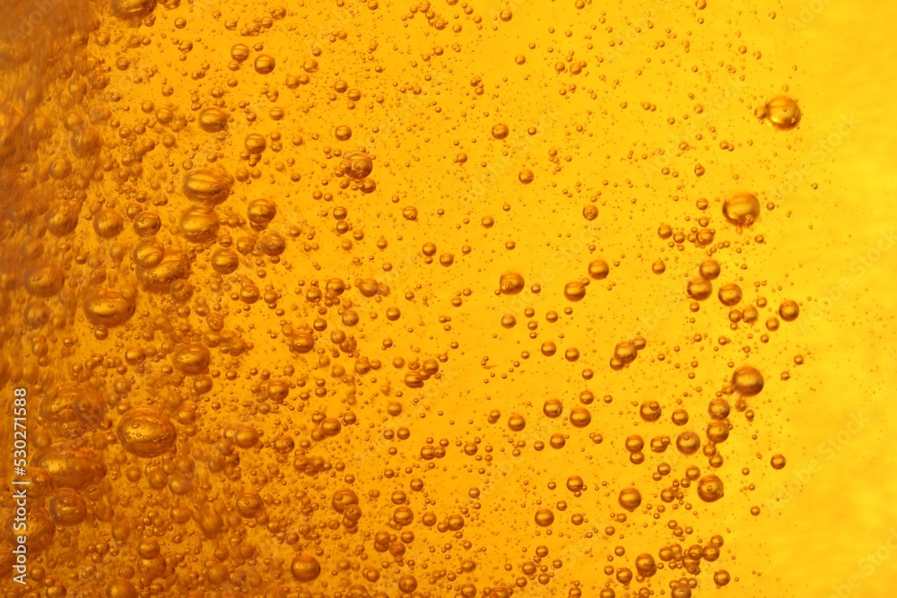 Tasty beer with bubbles as background, closeup Tasty beer with bubbles as background, closeup