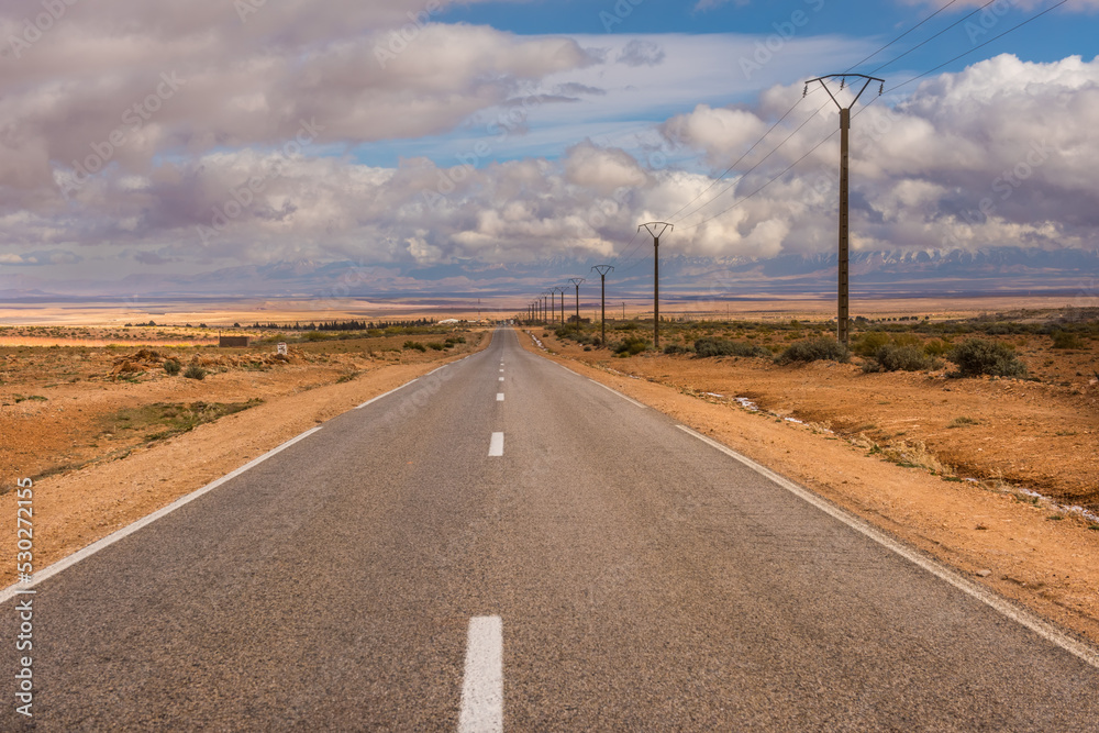 Endless asphalt road in dry stone Morocco desert Endless asphalt road in dry stone Morocco desert