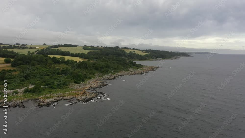 Drone flying cinematic over coastline at the sea in Denmark. The danish Island Bornholm in summer. Drone flying cinematic over coastline at the sea in Denmark. The danish Island Bornholm in summer.