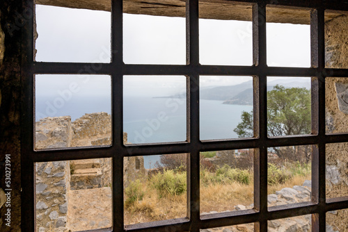 View of an old village ans the sea in Italy through a gate. Palermo  Sicily  Italy