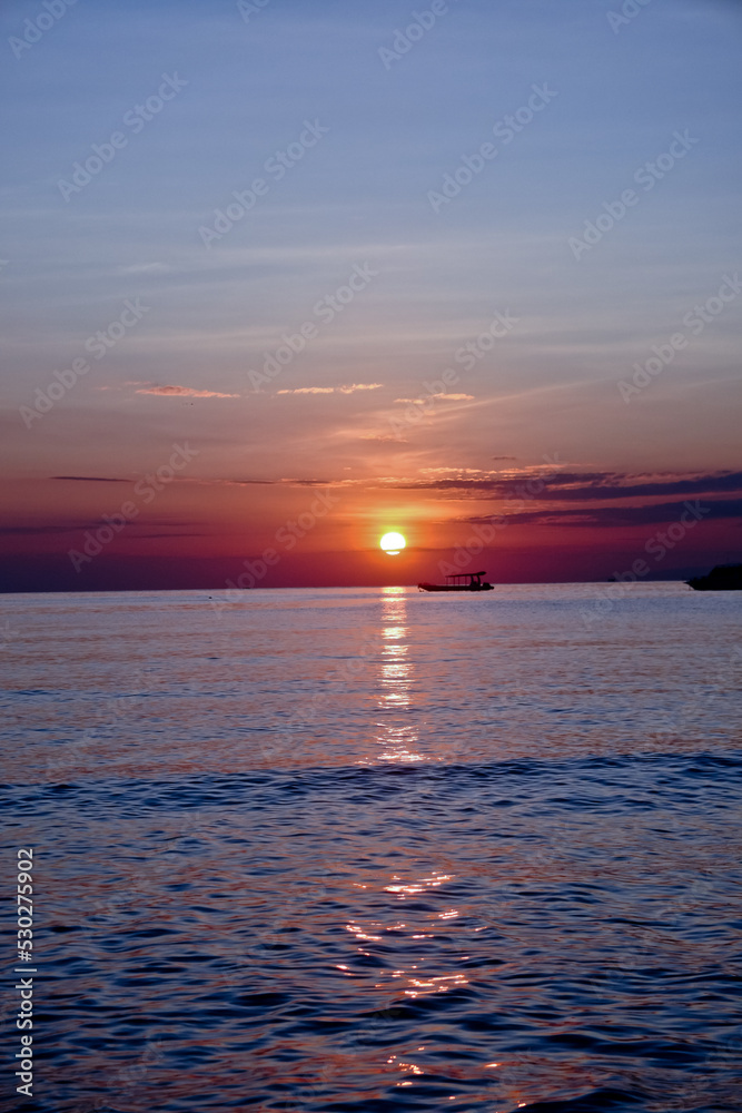 Obraz premium Sunrise with boat ship. West Bali, Indonesia