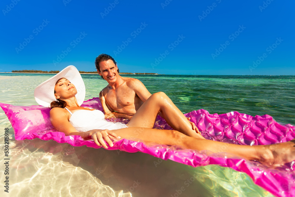 Young male female relaxing on inflatable air beds