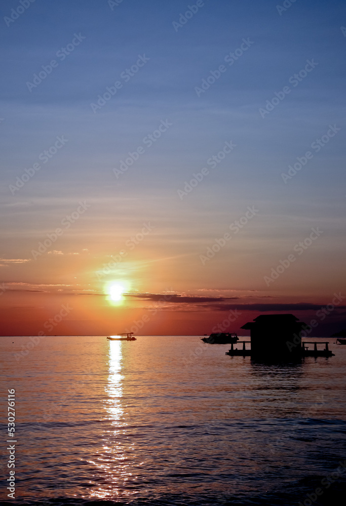 Sunrise with boat ship. West Bali, Indonesia