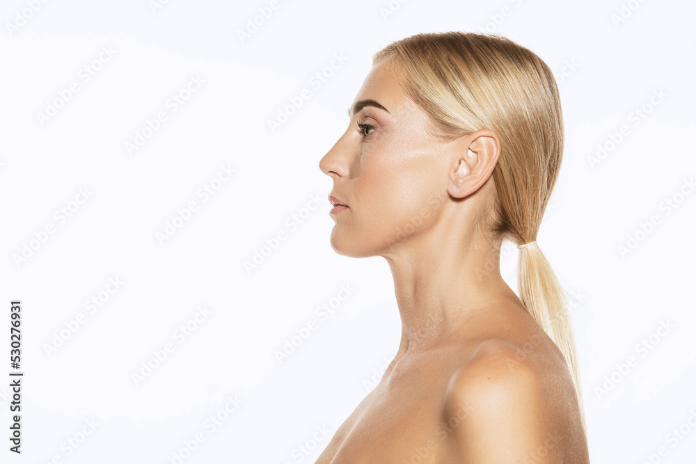 Profile view of young, beautiful 35 years old woman with well-kept skin isolated on white background. Spa, anti-aging treatment, face lifting and skin care Profile view of young, beautiful 35 years old woman with well-kept skin isolated on white background. Spa, anti-aging treatment, face lifting and skin care