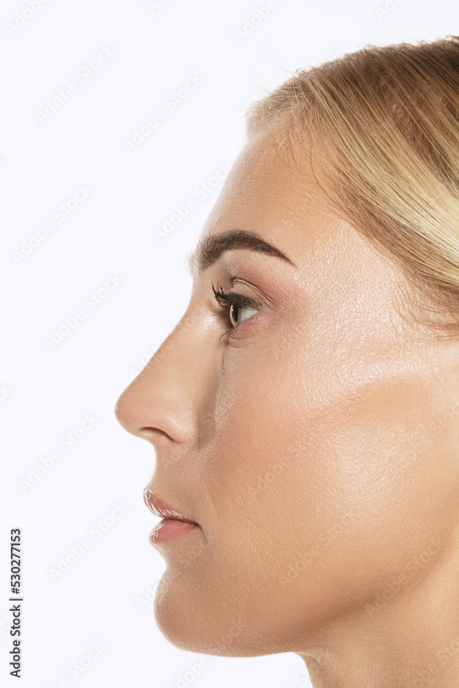 Profile view of beautiful young woman on white studio background. Concept of cosmetics, makeup, natural and eco treatment, skin care. Left side Profile view of beautiful young woman on white studio background. Concept of cosmetics, makeup, natural and eco treatment, skin care. Left side