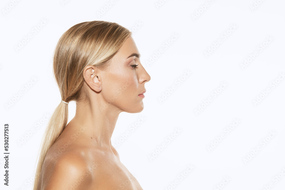 Profile view of young, beautiful 35 years old woman with well-kept skin isolated on white background. Spa, anti-aging treatment, face lifting and skin care Profile view of young, beautiful 35 years old woman with well-kept skin isolated on white background. Spa, anti-aging treatment, face lifting and skin care